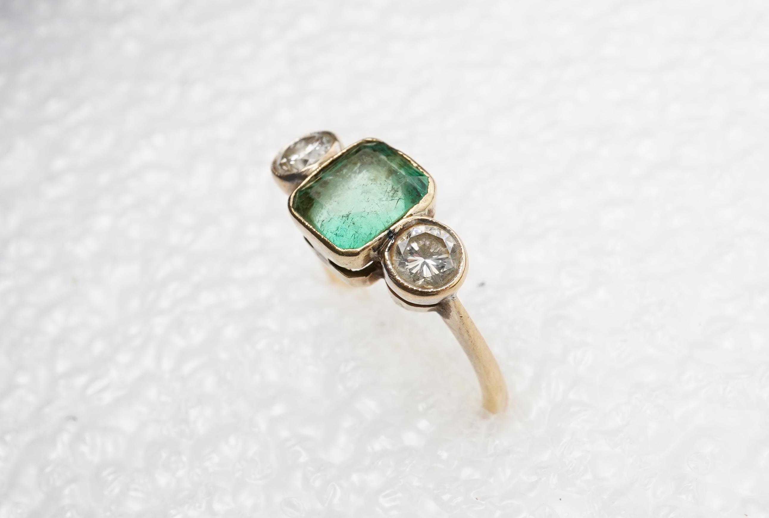An emerald and diamond ring